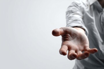 A person's hand wearing a white shirt is extended with the palm facing up against a white background. The image focuses on the arm and hand, creating a template for various design uses. High quality