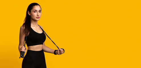 Fitness Model. Portrait Of Confident Young Woman In Black Sportswear Holding Jump Rope Wearing...