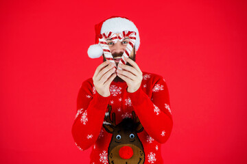 Santa Claus man at New Year eve. December holiday party for man in Santa hat. Xmas sweater....