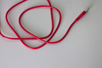 Red Micro usb charger for handphone. Cable phone chargers on white background	
