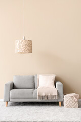 White living room with cozy sofa, carpet,  lamp and pillow