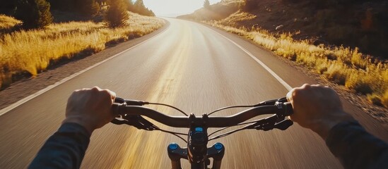 First-person view of cyclist on a sun-kissed asphalt road surrounded by nature