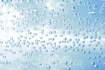 Soda water with bubbles of gas in glass, closeup