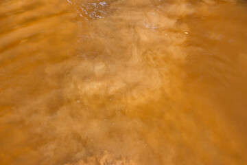 Sand raised from the bottom of a reservoir, muddy water in a river