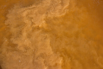 Sand raised from the bottom of a reservoir, muddy water in a river