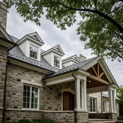 Obraz premium A stately stone house with a prominent front entrance, multiple dormers, and a large tree framing the top