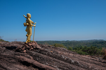 The Buddhist monk statue situated on Phu Langka mountain in Bueng Kan province of Thailand. This site is a prime viewpoint to watch the sunrise and landscape as far as Laos.