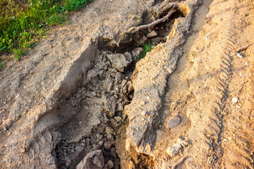 Erosion of sandy soil on a slope