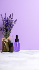 A small glass bottle of lavender essential oil sits beside a bunch of fresh lavender flowers, showcasing their vibrant purple hues and delicate petals.