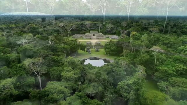 An aerial view captures the ancient mayan ruins of caracol, nestled amidst the lush green jungle of belize, showcasing the rich history and architectural marvels of this archaeological site
