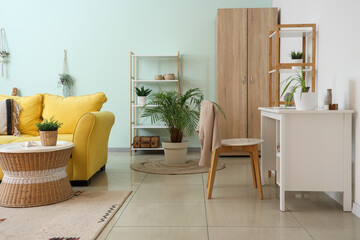 Interior of stylish modern living room with yellow sofa and houseplants