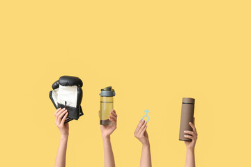 Female hands with boxing gloves, water bottles and male sign on yellow background. Prostate cancer...