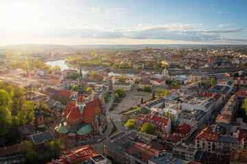 Colorful panorama of Podgorze district in Krakow, Poland during sunset at golden hour. 
Soft light, afternoon, panorama.
