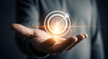 Glowing digital target with arrow held in open palm with sparkling lights hand