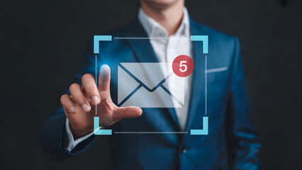 Businessman pressing glowing email icon with notifications on virtual screen