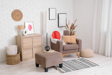Interior of living room with Japanese flag on armchair, pouf and frames