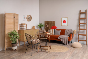 Interior of living room with Japanese flag pictures, sofa and armchairs