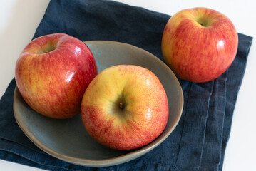 Three Fresh Envy Apples in a Bowl