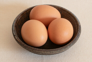 Three Pasture Raised Chicken Eggs in a Bowl