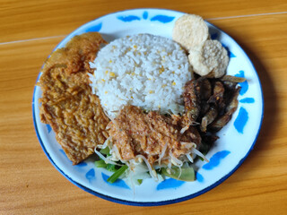 Nasi pecel or sego pecel is a typical Javanese Indonesian dish served with pecel sauce, which can...