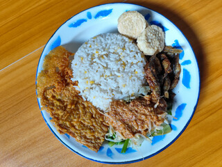 Nasi pecel or sego pecel is a typical Javanese Indonesian dish served with pecel sauce, which can...