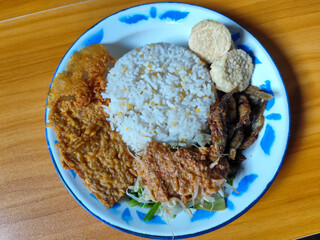 Nasi pecel or sego pecel is a typical Javanese Indonesian dish served with pecel sauce, which can...