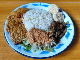Nasi pecel or sego pecel is a typical Javanese Indonesian dish served with pecel sauce, which can...