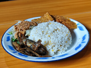 Nasi pecel or sego pecel is a typical Javanese Indonesian dish served with pecel sauce, which can...