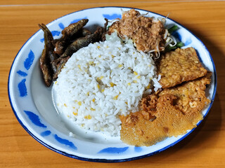 Nasi pecel or sego pecel is a typical Javanese Indonesian dish served with pecel sauce, which can...