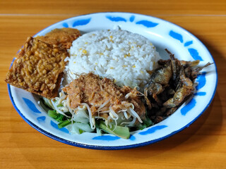 Nasi pecel or sego pecel is a typical Javanese Indonesian dish served with pecel sauce, which can...
