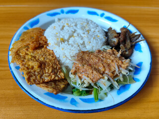 Nasi pecel or sego pecel is a typical Javanese Indonesian dish served with pecel sauce, which can...