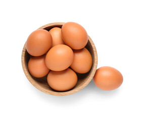 Wooden bowl with brown chicken eggs on white background