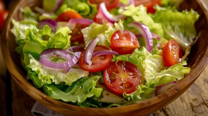 A simple but delicious salad featuring a mix of crisp iceberg lettuce ripe cherry tomatoes and tangy red onion slices.