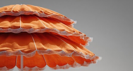 Orange beach umbrella tiers against pale gray sky