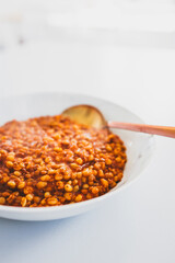 cooked freekeh with lentils and tomato sauce for a healthy vegetarian meal