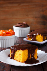 Slice of carrot cake with chocolate frosting on a ceramic plate. homemade Brazilian dessert