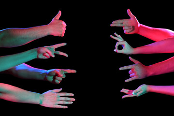 Toned many hands gesturing on dark background