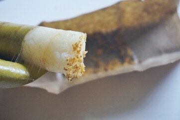 Lepet is a snack made from sticky rice and grated coconut and seasoned with salt, wrapped in young coconut leaves, cylindrical in shape and boiled. Indonesian food.