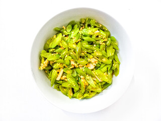 Tumis buncis or stir fry french bean or string beans served in white plate. Selective focus.