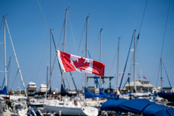 View of Canadian flag on boat at marina.