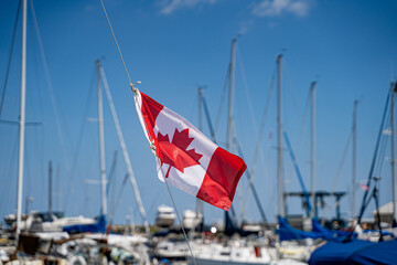 View of Canadian flag on boat at marina.