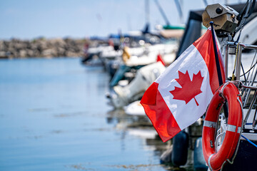 View of Canadian flag on boat at marina.