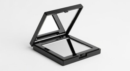 Open black compact mirror with reflective surface