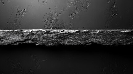 Dark stone shelf against textured wall