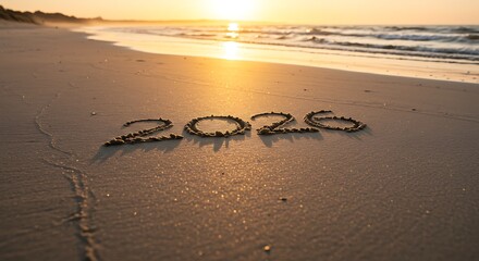 The year 2020 written in the sand on a scenic beach during sunset.