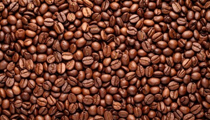 Fototapeta premium Aromatic texture of freshly roasted coffee beans background creating rich brown pattern