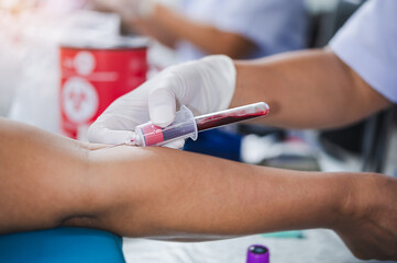 Close up hand of nurse, taking blood sample from a patient in the hospital.	
