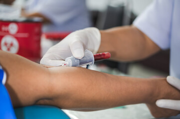 Close up hand of nurse, taking blood sample from a patient in the hospital.	
