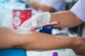 Close up hand of nurse, taking blood sample from a patient in the hospital.	