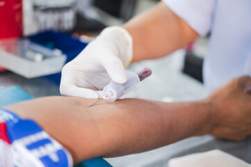 Close up hand of nurse, taking blood sample from a patient in the hospital.	